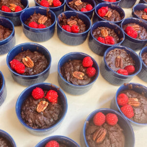 Vegan chocolate dessert pots topped with raspberries and pecans served at a UK wedding by Vegan Junkies