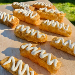 Deep fried marinated tofu with garlic mayo on a wooden board served at a UK wedding by Vegan Junkies