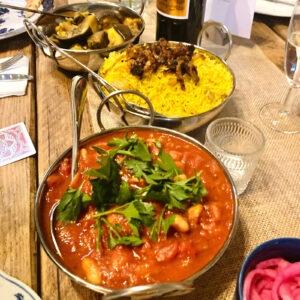 Vegan Indian sharing curry dishes in balti bowls served at a UK wedding by Vegan Junkies