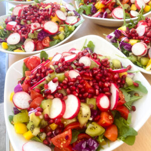 Vibrant vegan pomegranate and radish rainbow salad served at a UK wedding by Vegan Junkies
